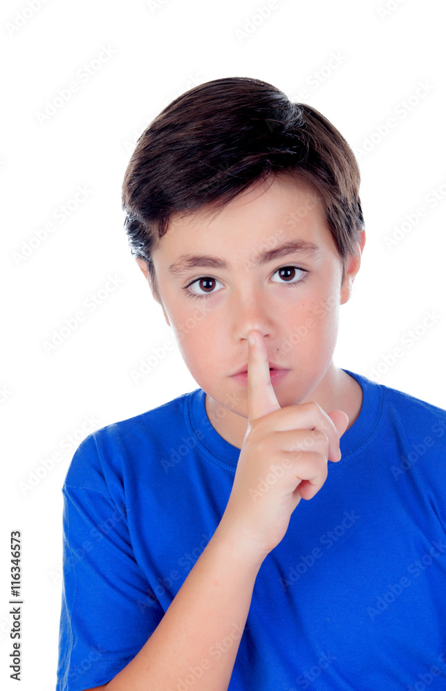Little boy with ten years old indicating silence Little boy with ten years old indicating silence