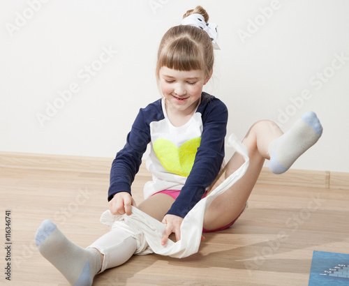 Fotografie Funny little girl dressing