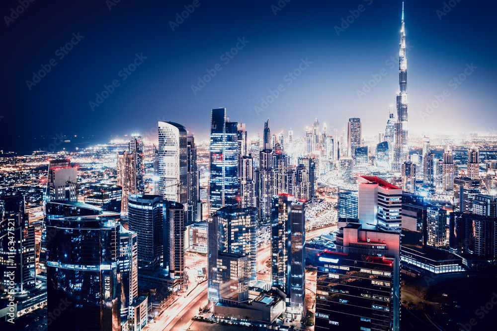 Fototapeta premium Scenic top view of a big modern city by night. Business bay, Dubai, United Arab Emirates.