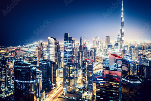 Scenic nighttime skyline  big modern city with illuminated skyscrapers. Business bay  Dubai  UAE.