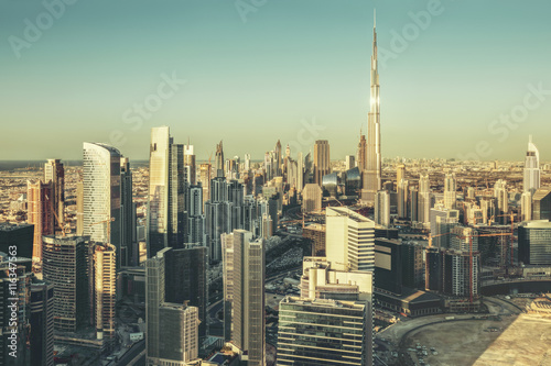 Fantastic architectural background. Panoramic Dubai cityscape with skyscrapers at sunset. Scenic travel background.