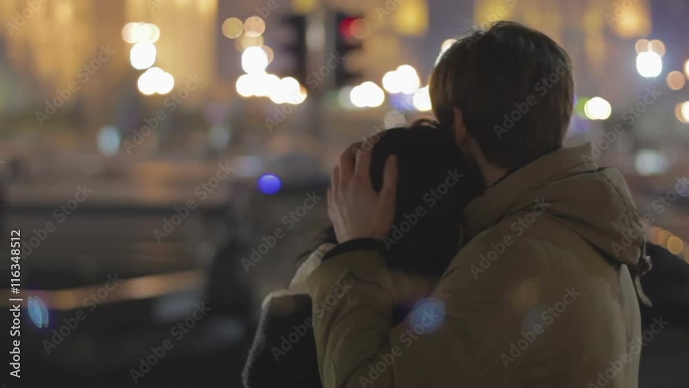 Young happy couple hugging on date, enjoying night city view, relationship Young happy couple hugging on date, enjoying night city view, relationship