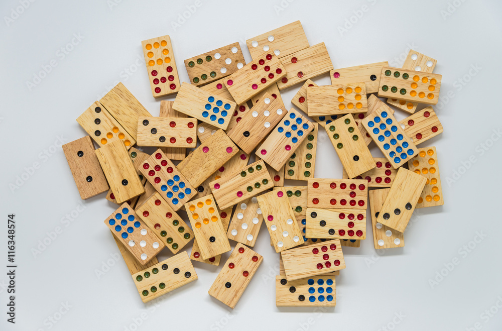Lots of wooden dominoes on white background with selective focus Lots of wooden dominoes on white background with selective focus