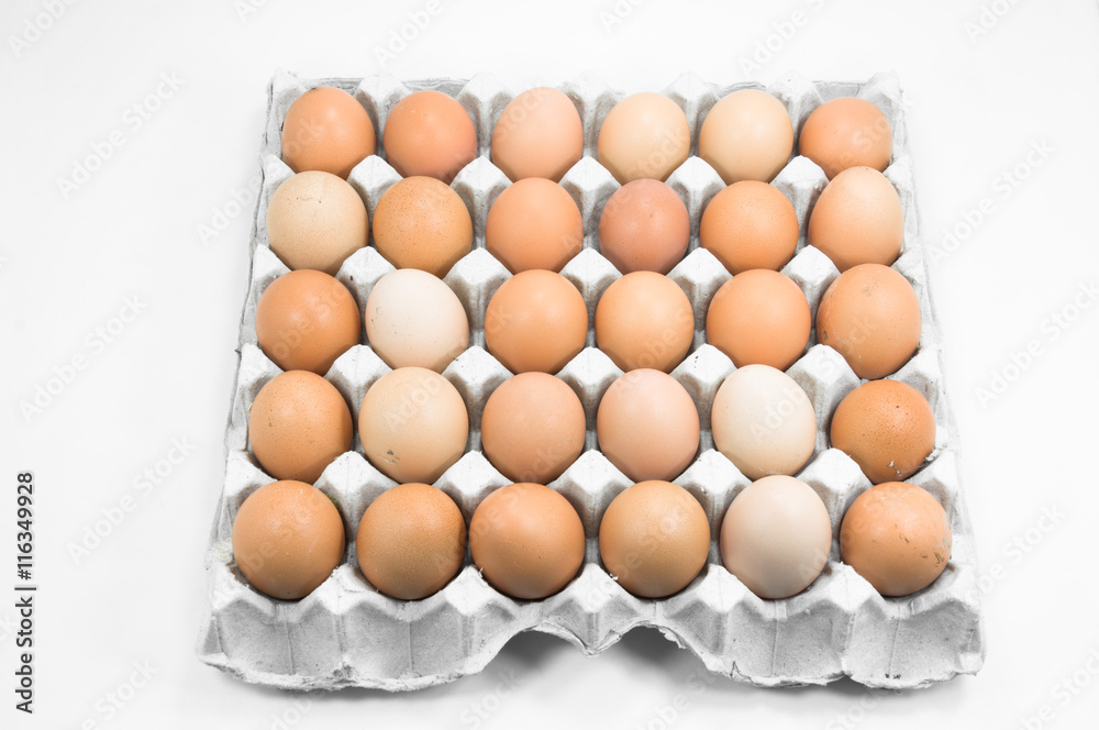 Eggs in paper tray on white background,Brown eggs in an egg carton