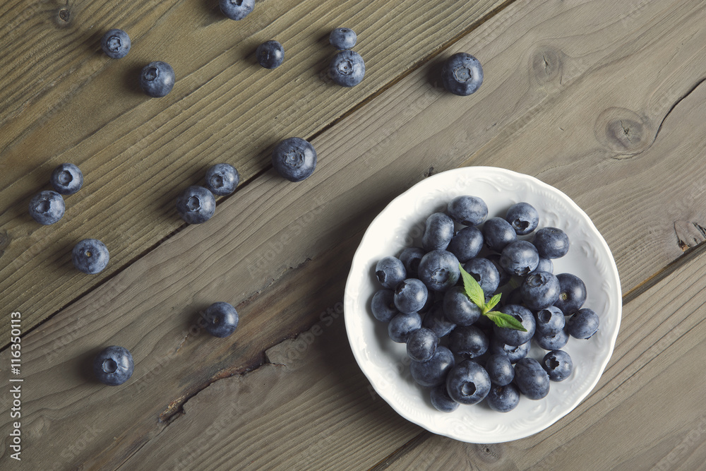 blueberries on rustic table / overhead portrait of blueberries on wood top blueberries on rustic table / overhead portrait of blueberries on wood top