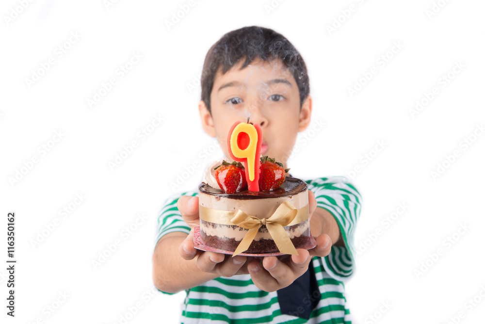 Little boy browing candle on the cake for his birthday Little boy browing candle on the cake for his birthday