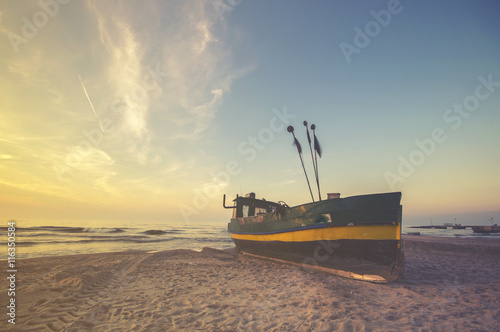 fishing boats on the sea beach sunset  Vintage retro stylized photo  
