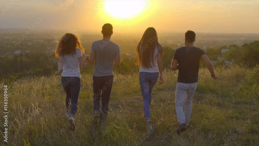 3 in 1 video! The people jump on the background of sunset. Wide angle. Slow motion. Crane shot with camera pitch