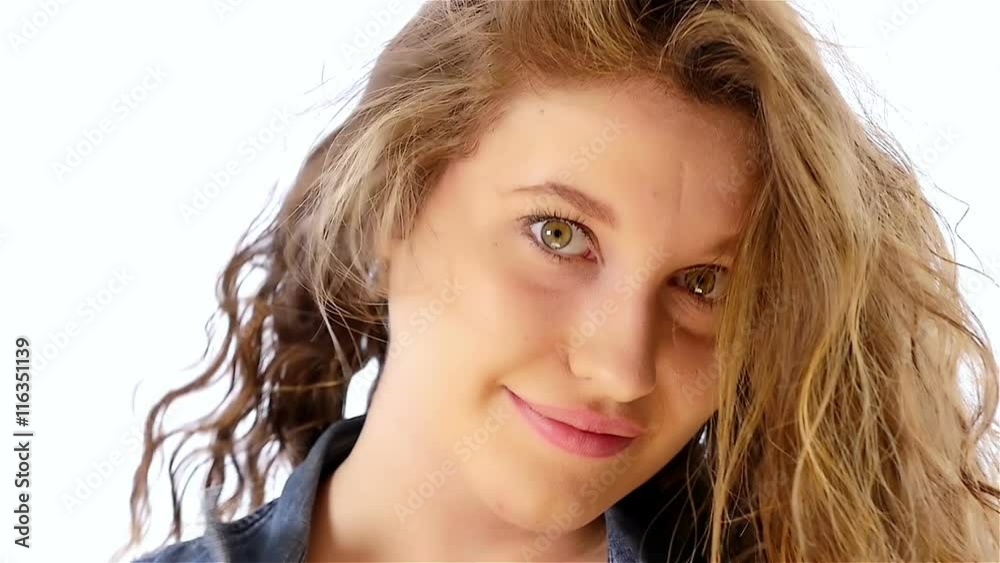 Portrait of a beautiful teenager girl on a white background, slow motion Portrait of a beautiful teenager girl on a white background, slow motion