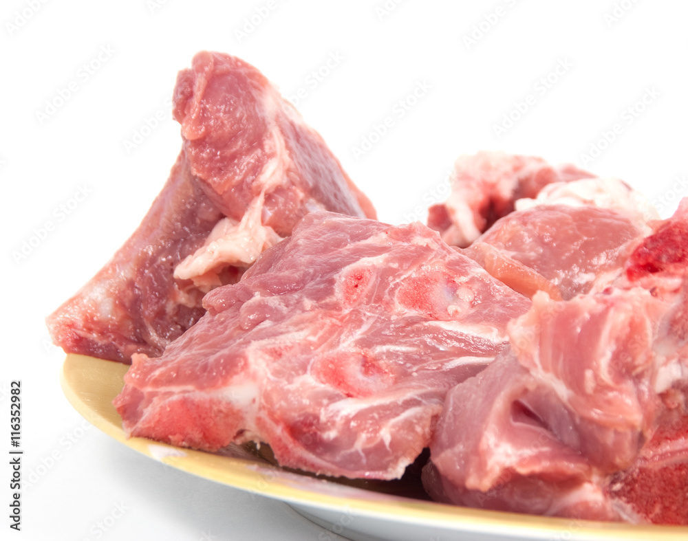 Peaces of pork on bones on the plate a white background Peaces of pork on bones on the plate a white background