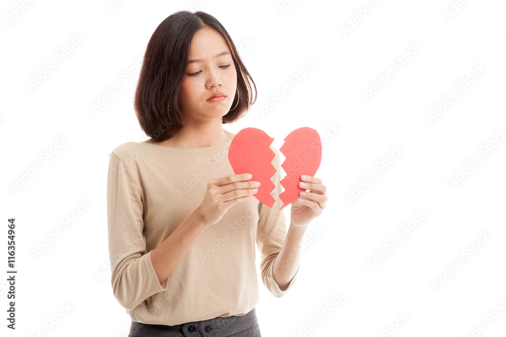 Beautiful young Asian woman with broken heart isolated on white background Beautiful young Asian woman with broken heart isolated on white background