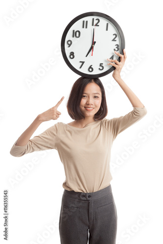 Young Asian business woman point to a clock  isolated on white background