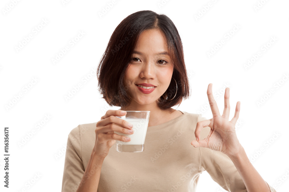 Healthy Asian woman drinking a glass of milk show OK sign isolated on white background Healthy Asian woman drinking a glass of milk show OK sign isolated on white background