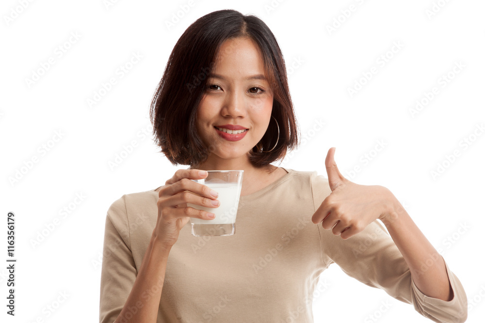 Healthy Asian woman drinking a glass of milk thumbs up isolated on white background Healthy Asian woman drinking a glass of milk thumbs up isolated on white background
