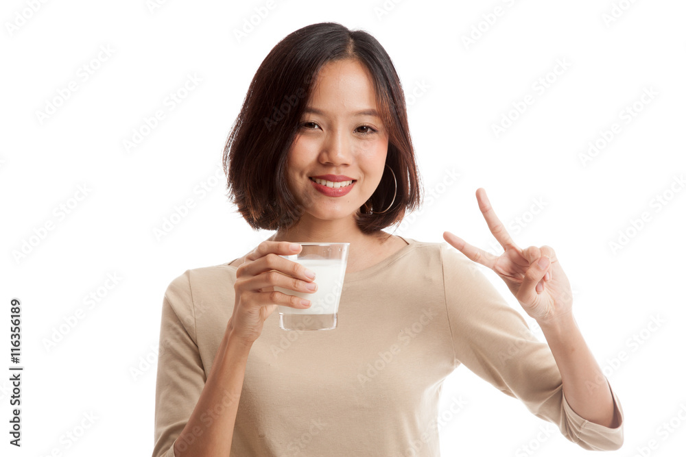 Healthy Asian woman drinking a glass of milk show victory sign isolated on white background Healthy Asian woman drinking a glass of milk show victory sign isolated on white background