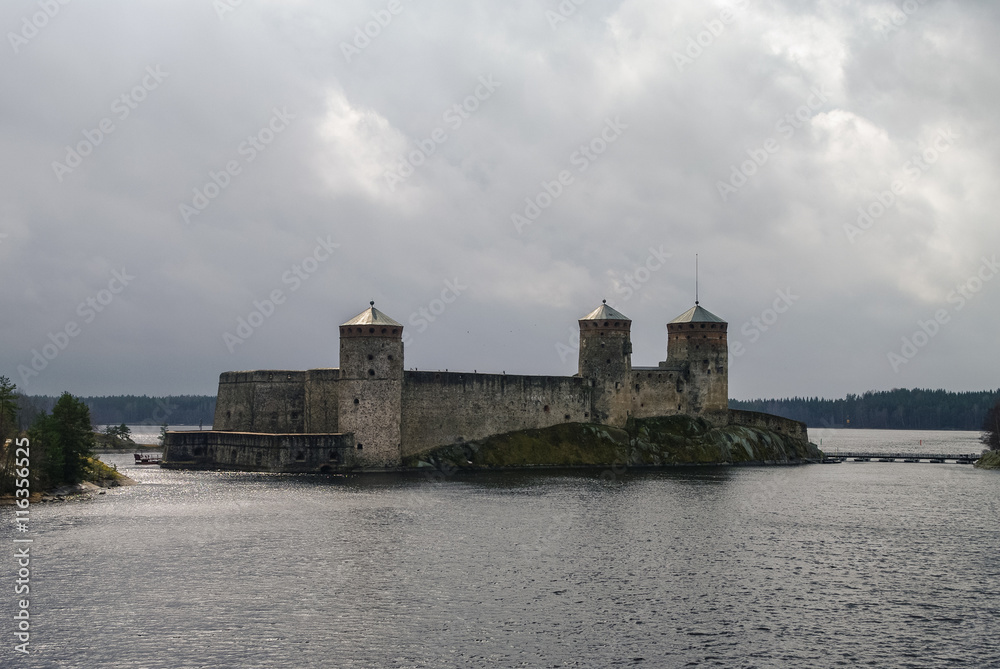 Olavinlinna fortress and Kuussalmi bay of Lake Saimaa  at rainy weather. Savonlinna, Finland.