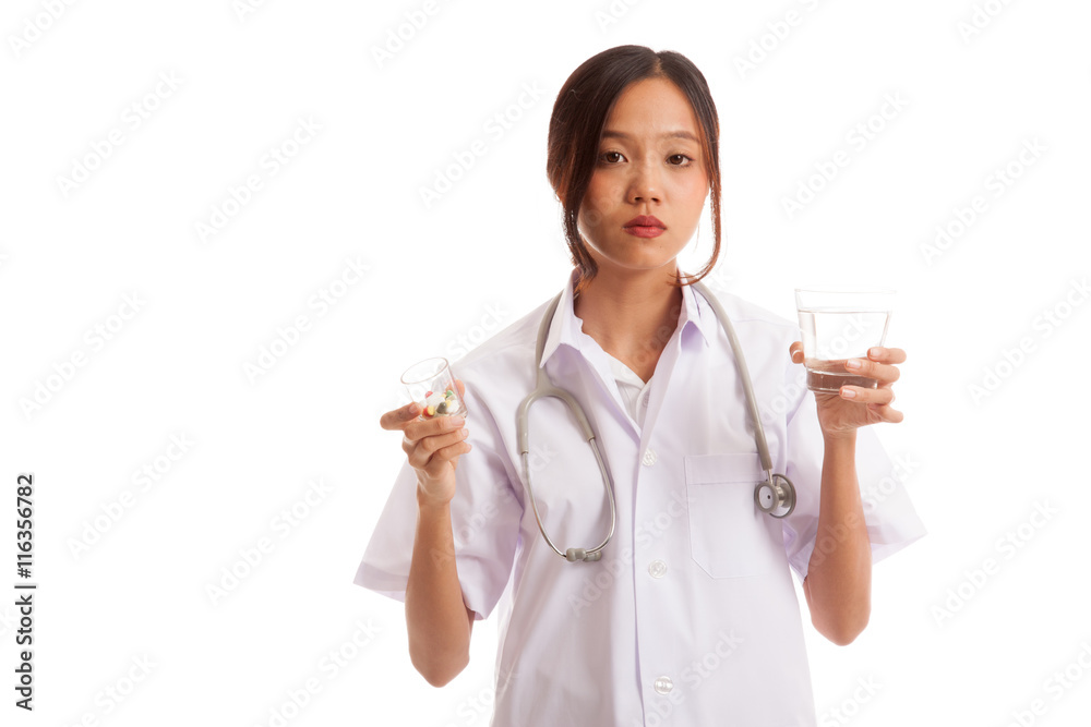 Young Asian female doctor with water and medicine isolated on white background Young Asian female doctor with water and medicine isolated on white background