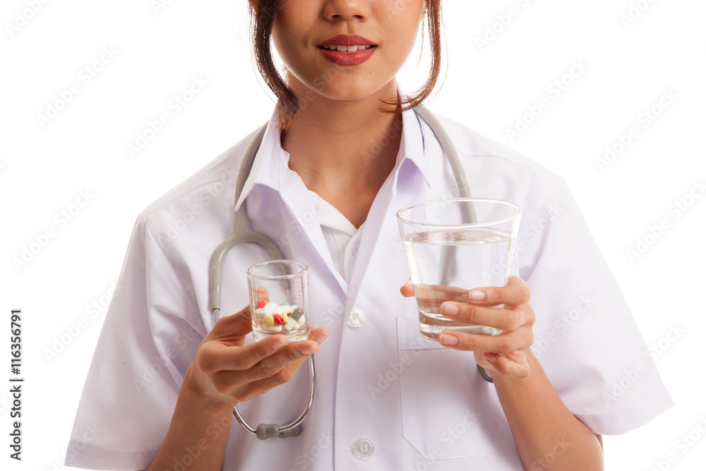 Young Asian female doctor with water and medicine isolated on white background Young Asian female doctor with water and medicine isolated on white background