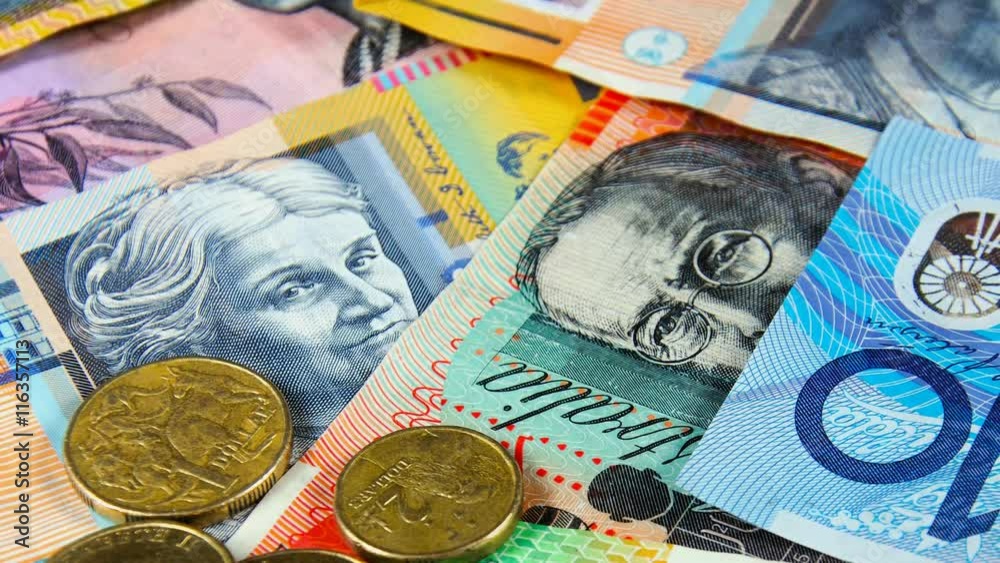 Australian money close up with ten, twenty, fifty, and five dollar notes, and one and two dollar gold coins.