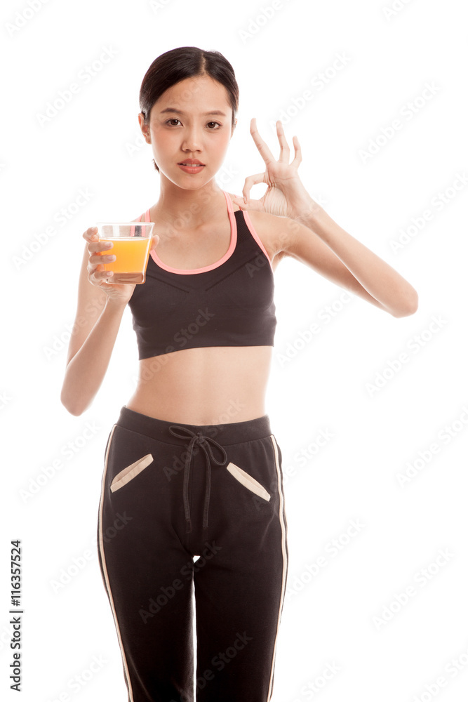 Beautiful Asian healthy girl drinking orange juice show OK sign isolated on white background Beautiful Asian healthy girl drinking orange juice show OK sign isolated on white background