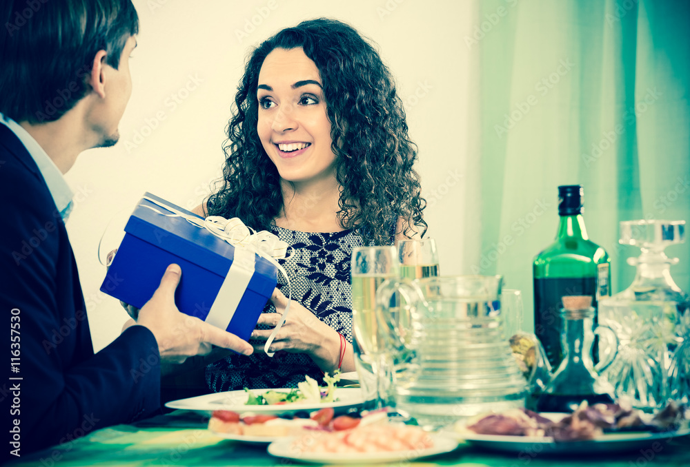 Fototapeta premium Man giving present to woman