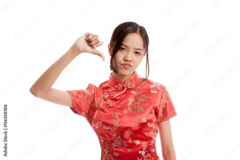 Asian girl in chinese cheongsam dress thumbs down isolated on white background Asian girl in chinese cheongsam dress thumbs down isolated on white background