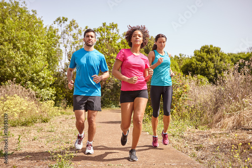 Three joggers on a leisurely run