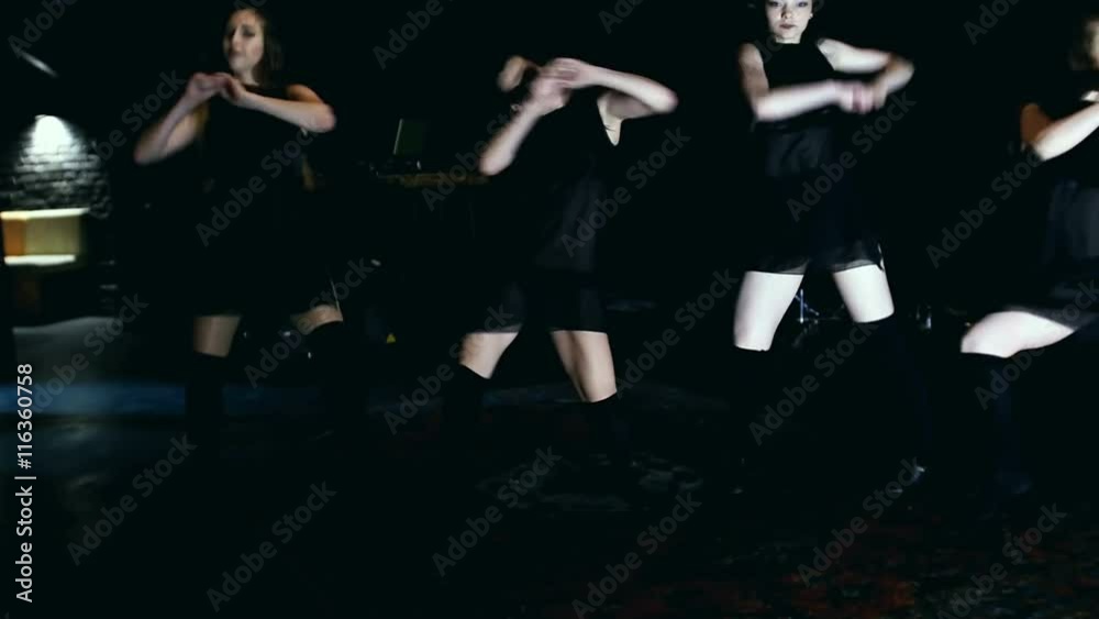 Contemporary dance performance of four dancers on dark Contemporary dance performance of four dancers on dark