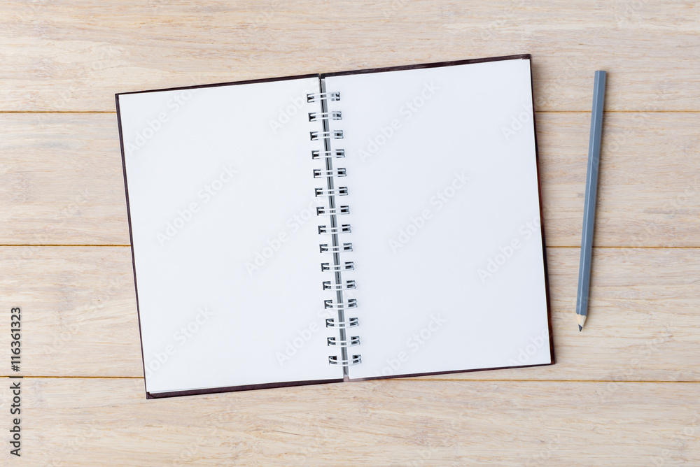 Open notebook with pencil on wooden background Open notebook with pencil on wooden background