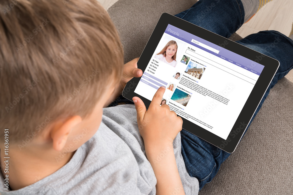 Cute Little Boy Using Social Networking Site On Digital Tablet Cute Little Boy Using Social Networking Site On Digital Tablet