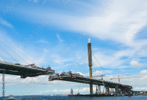 The construction of a cable-stayed road bridge across the river.