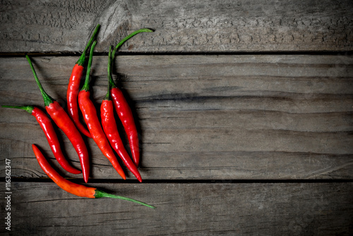 Top view of red chilli pepper on wooden background