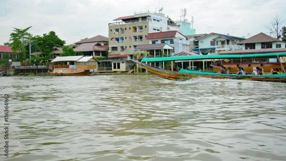 Video 1080p - Long wooden boat carries passengers along the river. Thailand, Ayutthaya Video 1080p - Long wooden boat carries passengers along the river. Thailand, Ayutthaya