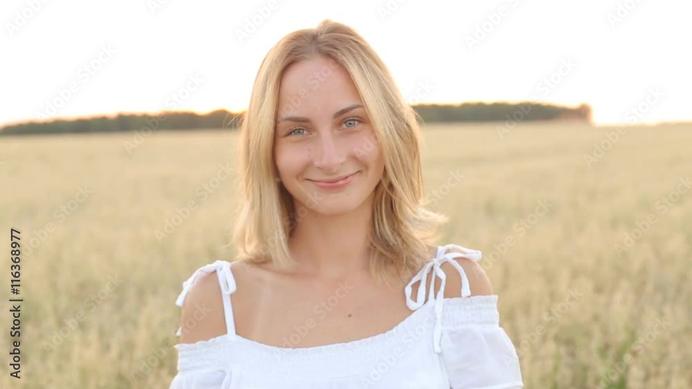 Beauty Girl with Healthy Hair Outdoors. Happy Smiling Young Woman falling