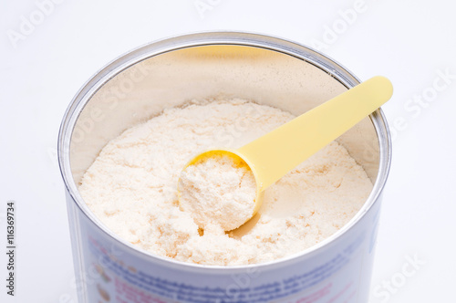 Baby milk powder in cans that open with a spoon.