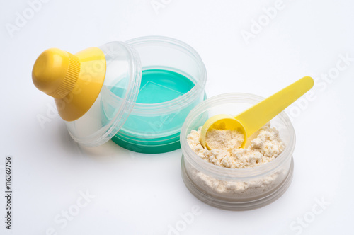 Container of powdered milk for infants on white background.