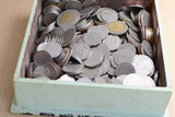 coins in wooden  tray