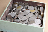 coins in wooden  tray