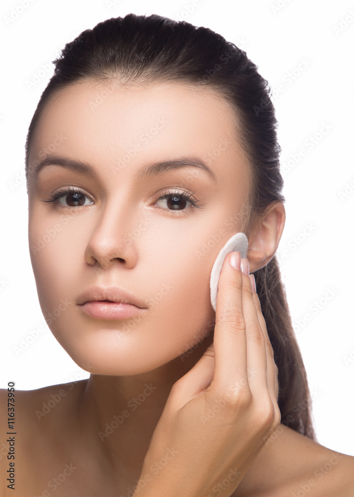 Happy european woman with cotton pad, isolated on white background. Beauty fresh girl cleaning face with cotton swab. Beautiful young woman cleaning her face with cotton