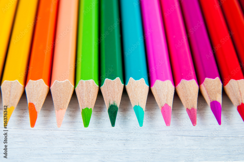 Multicolor pencils, on a wooden white background, close up Multicolor pencils, on a wooden white background, close up