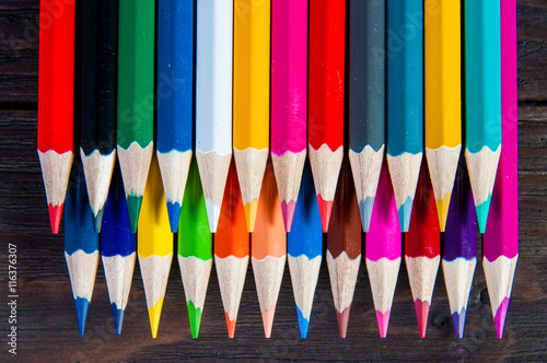 Multicolor pencils, on a wooden white background, close up