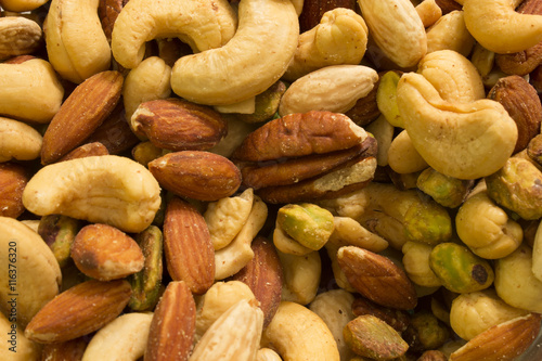 This is a photograph of mixed nuts including Cashews,Almonds,Pistachios and Pecans photo