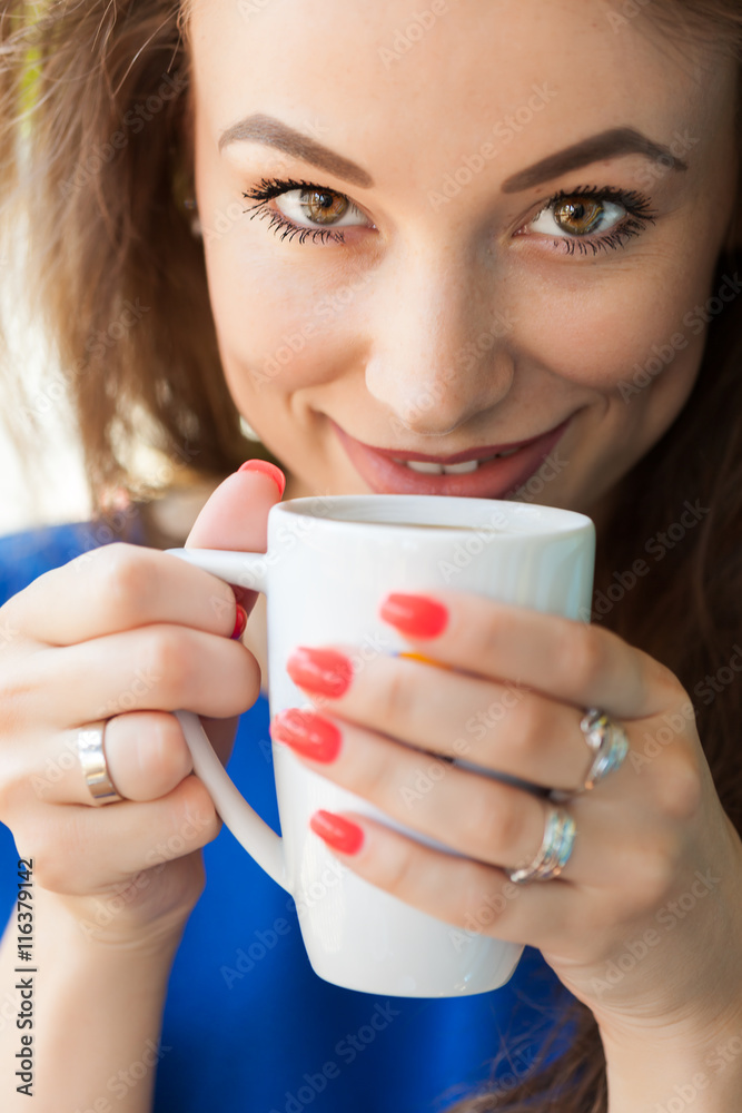 Beautiful woman looking up and drinking a cup of coffee Beautiful woman looking up and drinking a cup of coffee