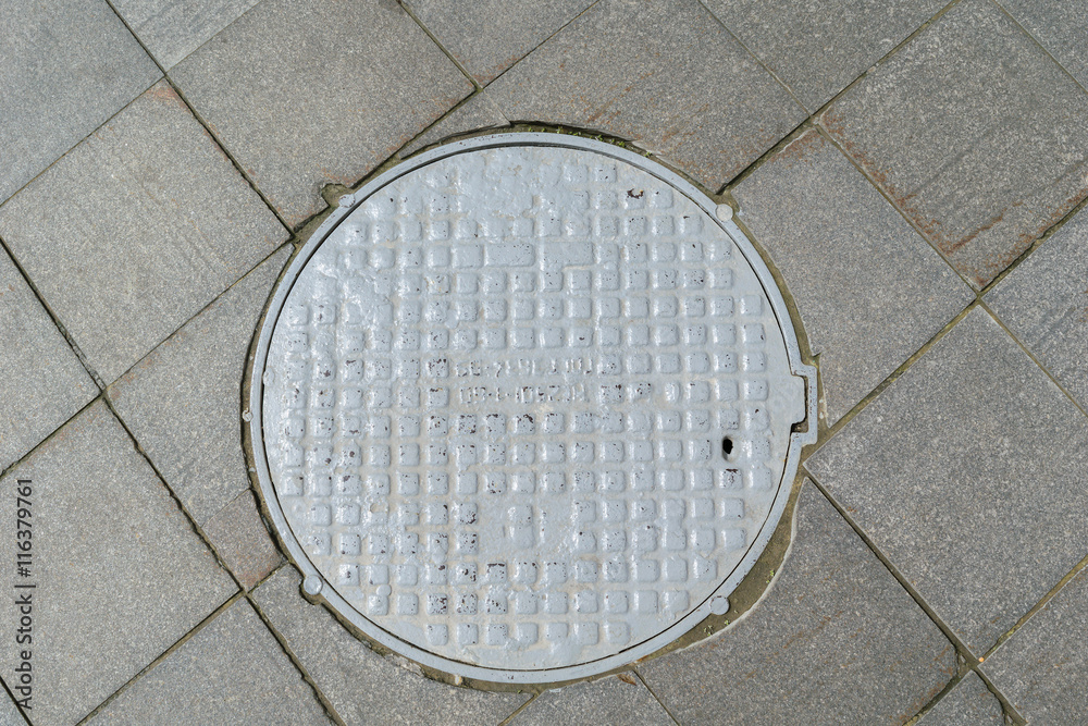 Grey metal cover of the hatch covering the technology pit