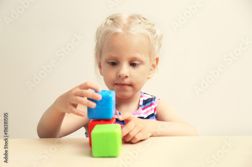 Funny little girl hiding be...