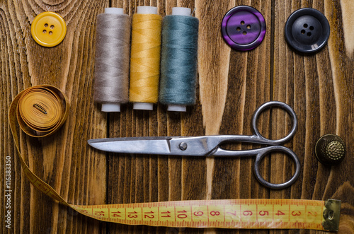 Composition with accessories for sewing and crafts on a wooden s photo