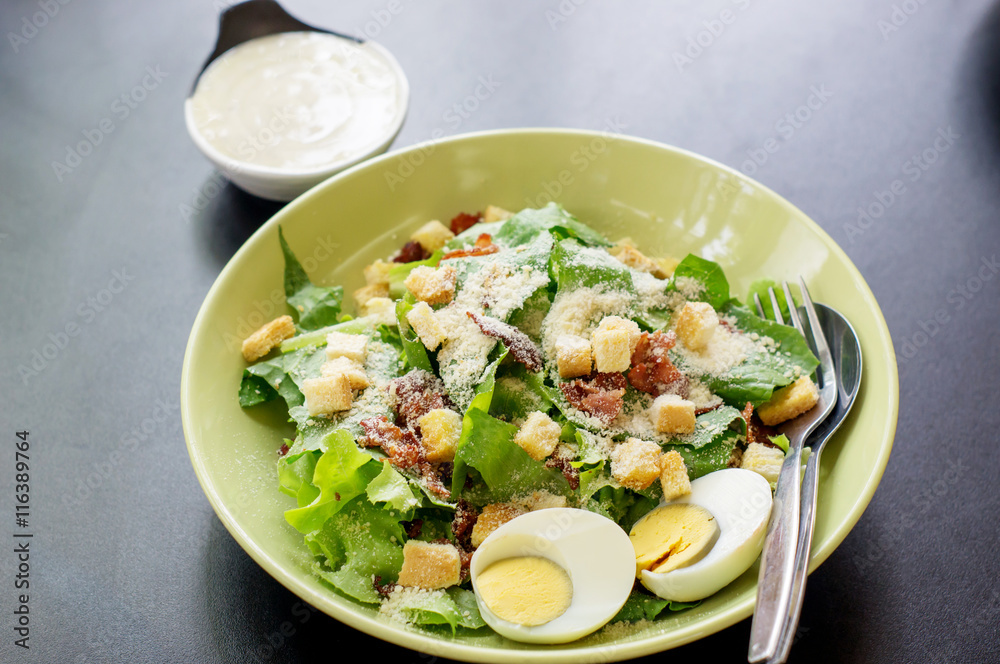 Caesar salad in a white bowl. Caesar salad in a white bowl.