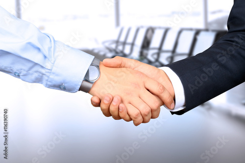 Close-up image of a firm handshake between two colleagues