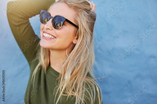 Cheerful young woman in sunglasses
