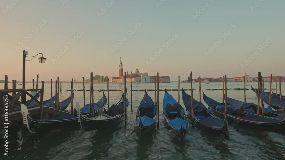 Parking gandolas on the Doge's palace embankment with the bell tower of the Saint Giorgio Maggiore church view. Parking gandolas on the Doge's palace embankment with the bell tower of the Saint Giorgio Maggiore church view.